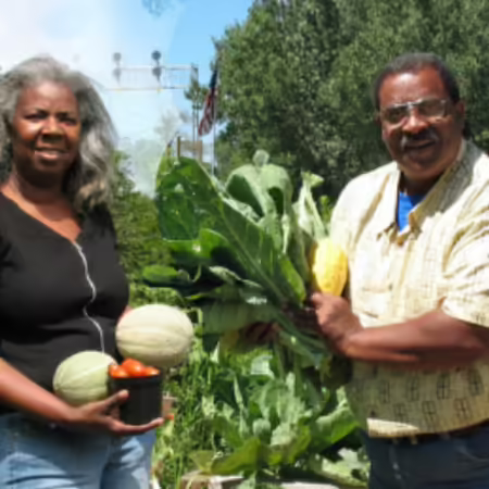 Michael Howard and his wife Amelia Howard hold vegetables from their farm