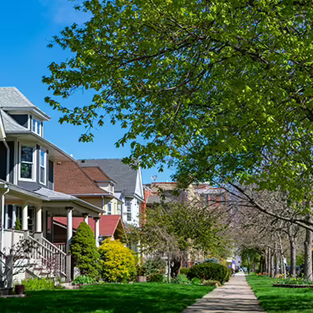 a row of homes along an urban sidewalk