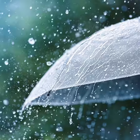 Raindrops falling onto an umbrella