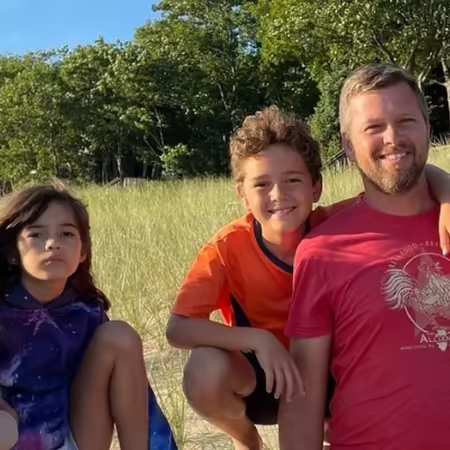 Clint poses with his wife and 4 kids