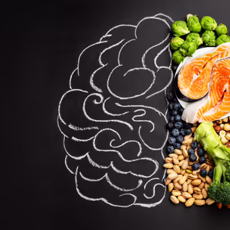 A drawing of a brain with a variety of food representing half of it.