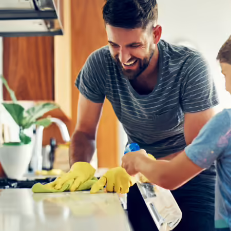 a father and son cleaning the kitchen