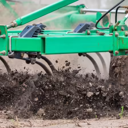 Tillage equipment moving through farm field