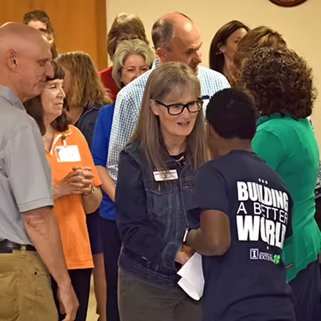 Dr. Shelly Nickols-Richardson shaking hands with a 4-H teen
