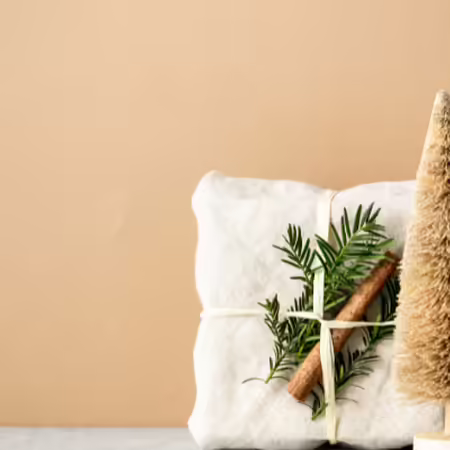Gift wrapped in cloth with greenery for decoration