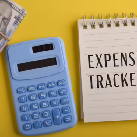 blue calculator and a notebook that says Expense Tracker