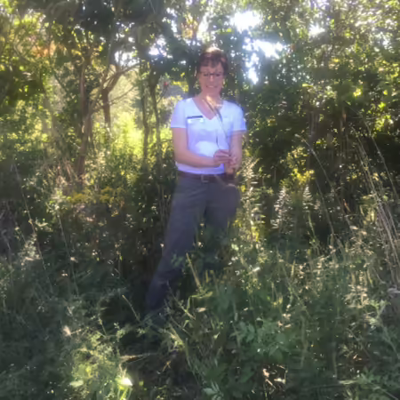woman outside holding a grass