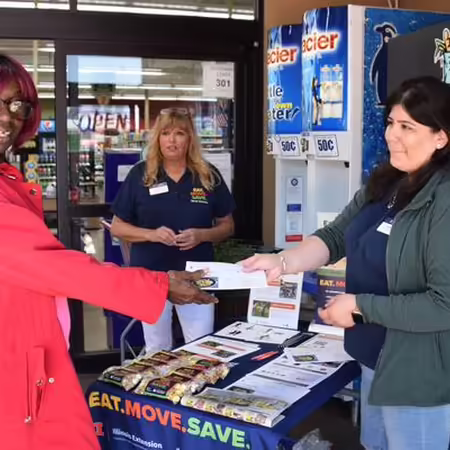 Adult giving another adult a brochure