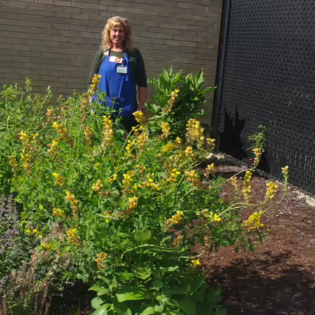 Kristen Dimas standing in the humming bird habitat at Southside Occupational Academy