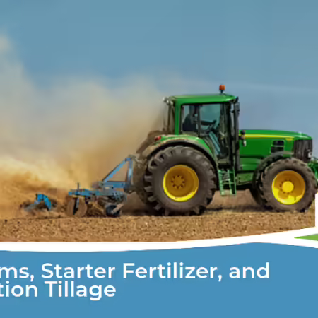 Tractor plowing a field with a dust cloud behind