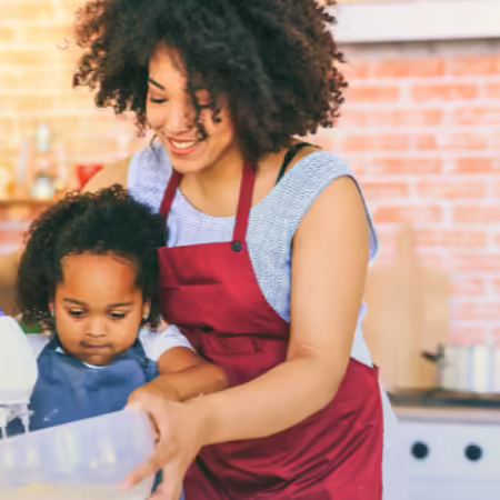 Image of a mother and small child cooking together in a kitchen