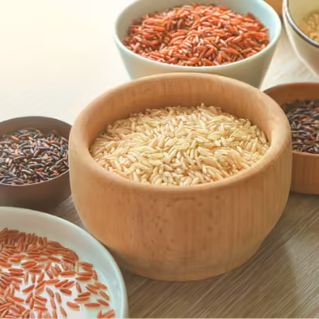 Bowls of brown, red, and purple rice
