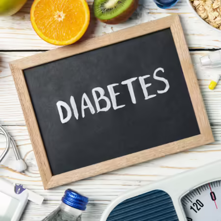 Image of chalkboard with the word Diabetes. Surrounding the chalkboard are the items: dumbbell, stethoscope, scale, medication, fruit, oatmeal, diabetic measuring device 