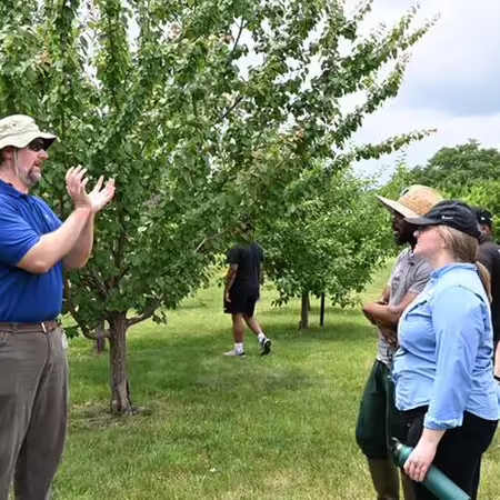 Dr Jon Fisher teaching in orchard
