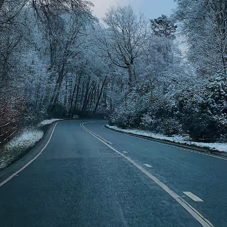 road in winter surrounded by snow
