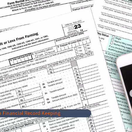 Photo of financial forms with calculator on top.