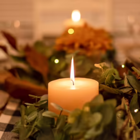 A lit candle on a table