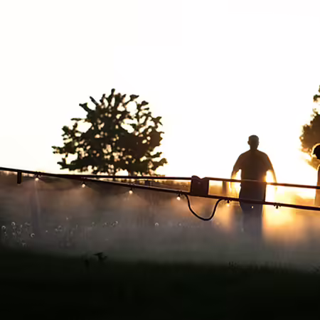 people next to a sprayer
