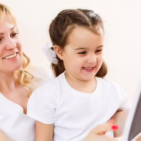 Mother and daughter looking at an electronic tablet