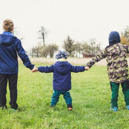 three children holding hands