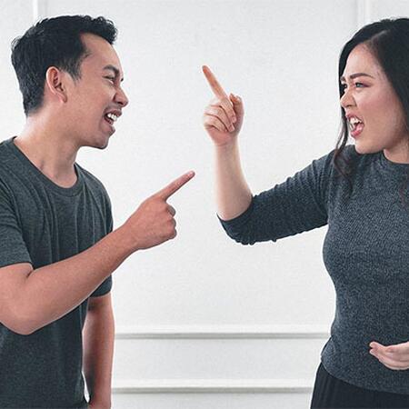 man and woman pointing at each other and yelling
