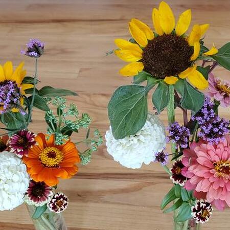 Two colorful bouquets on a wood table