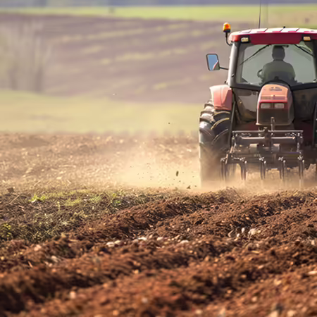 red cab tractor pulling a piece of tillage equipment through a field