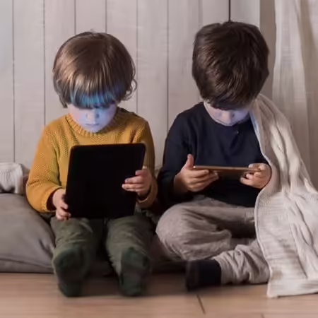 2 children on their tablets