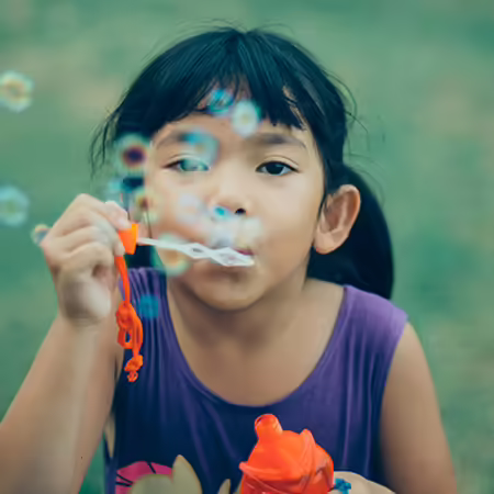 girl blowing bubbles
