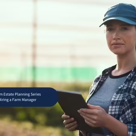 lady with a tablet standing in a greenhouse