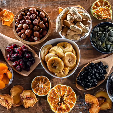 A group of bowls of dried fruits and nuts