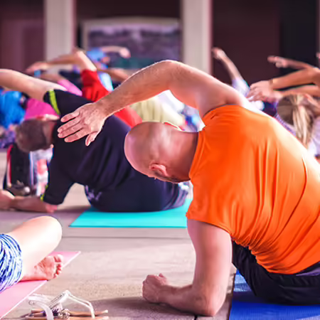 Group of people stretching and sitting on the floor