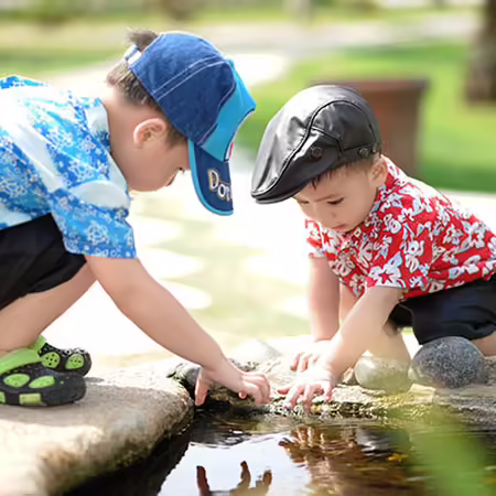 Two small children playing in water