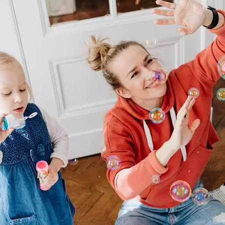 Mother and child blowing bubbles 
