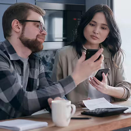 couple looking at each other's phones