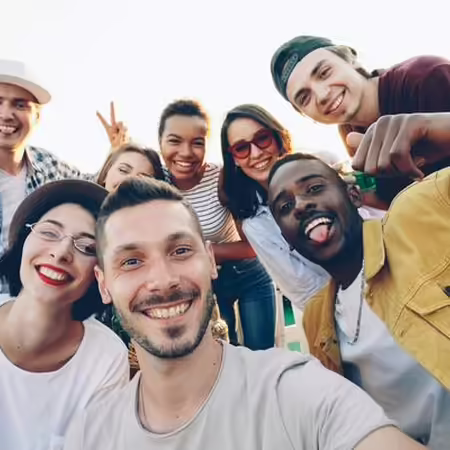 Group of people smiling and posing for a picture