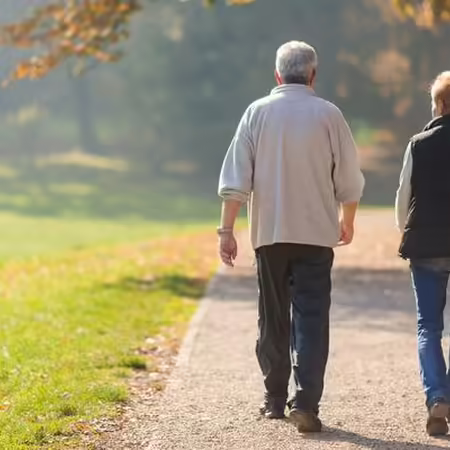 man and women walking in the park