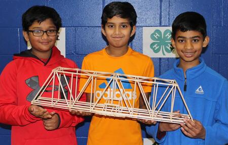 4-H students at Annual Bridge Bust Event holding their creation