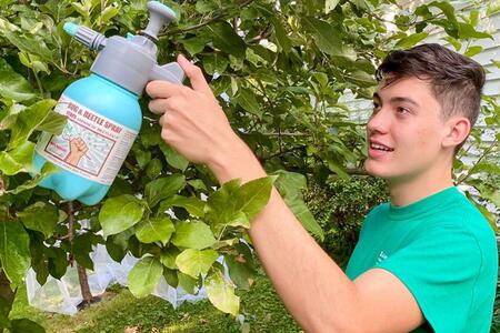 Matias Habib of Sandwich, Ill., sprays his biopesticide product for Japanese beetles. Habib has filed for a patent and started his own company, TerraBuster. One of four national 2023 4-H Youth In Action award recipients, Habib won the agriculture award.