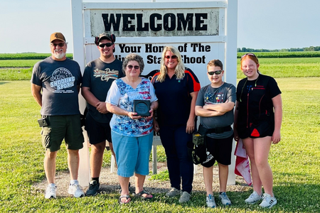 Macoupin County 4-H staff member and 4-H members presenting Brittany Shooting Park owner Carol Mohr with Community Partner Award