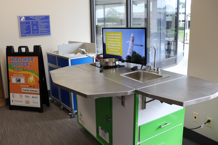 A mobile teaching kitchen is set up for display.