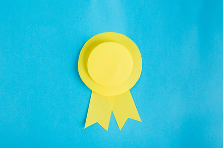 yellow award ribbon on blue background