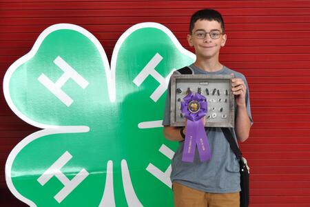 4-H member with ribbon and project