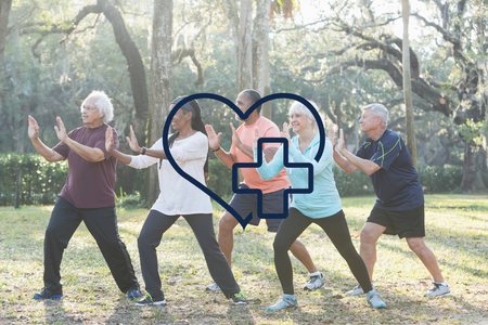 image of a group of people doing tai chi outdoors with a graphic of a cross and a heart.