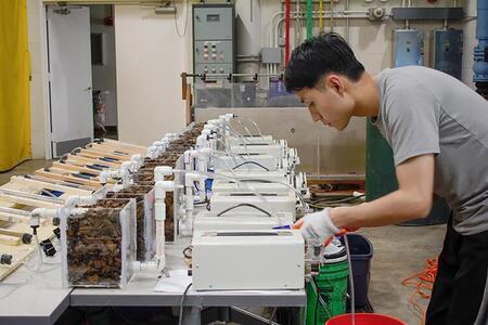 A man adjusts equipment in a lab