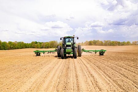 Tractor driving in a dirt field
