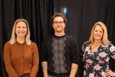 three people at conference who won award