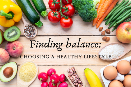 raw vegetables and fruit displayed on wood floor background