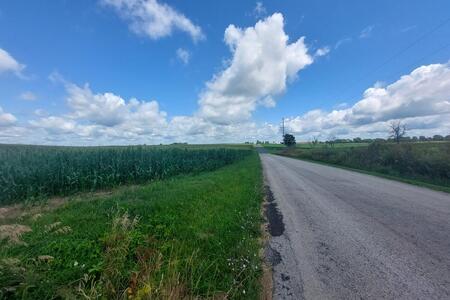 country road with blue sky and white clouds