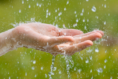 Person catching raindrops
